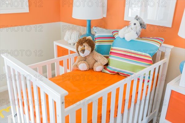 Bright vibrant orange baby room interior of house
