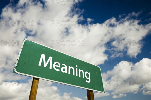 Meaning road sign with dramatic clouds and sky