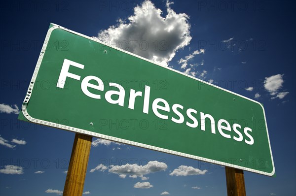 Fearlessness road sign with dramatic blue sky and clouds