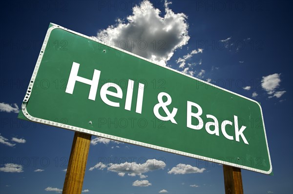 Hell and back road sign with dramatic clouds and sky