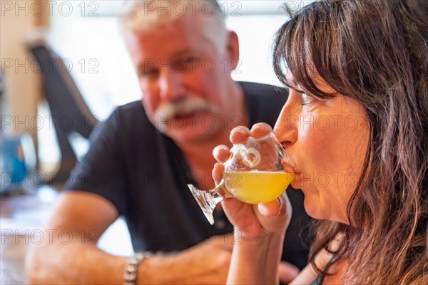 Couple enjoying glasses of micro brew beer at bar