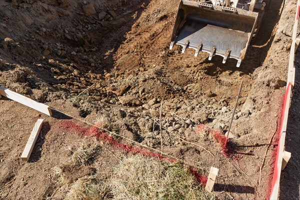 Small bulldozer digging in yard for pool installation