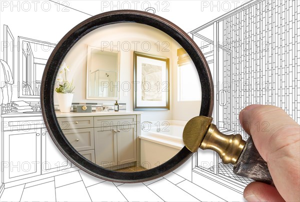 Hand holding magnifying glass revealing finished bathroom build over drawing
