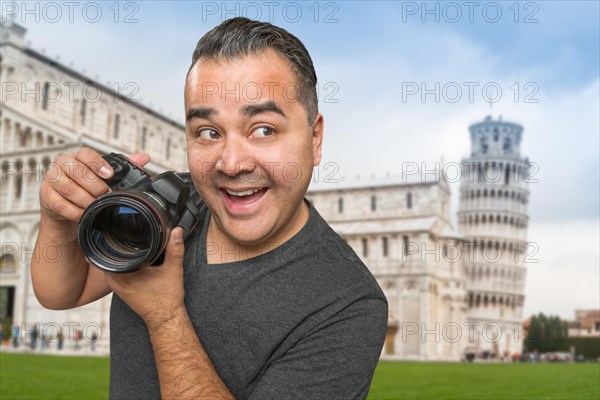 Hispanic male photographer with camera at leaning tower of pisa