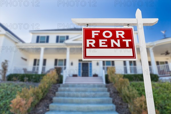 Left facing for rent real estate sign in front of house