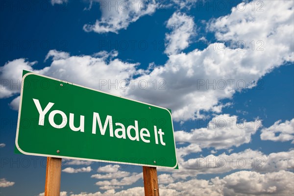 You made it green road sign with dramatic clouds and sky