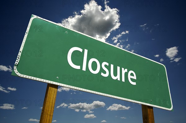 Closure road sign with dramatic clouds and sky