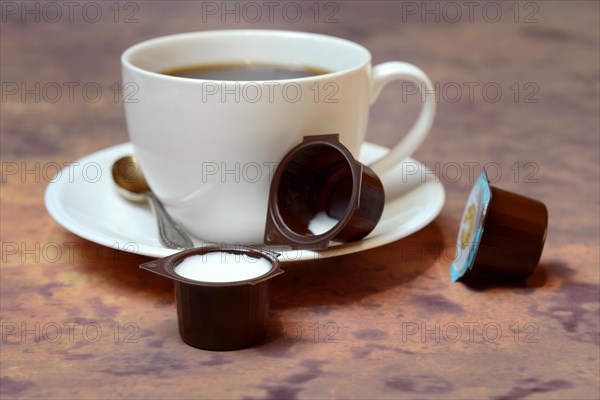Cup of coffee and milk in portion pack