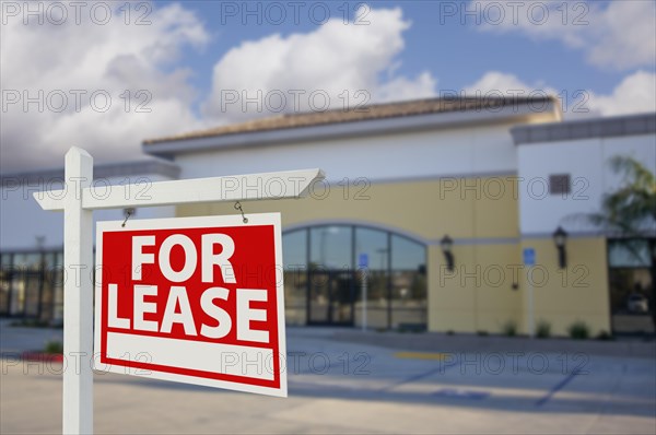 Vacant retail building with for lease real estate sign in front