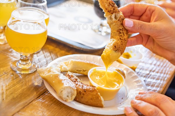 Woman enjoys warm pretzels and micro brew beer