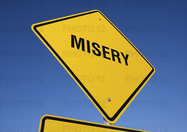 Misery yellow road sign against a deep blue sky with clipping path
