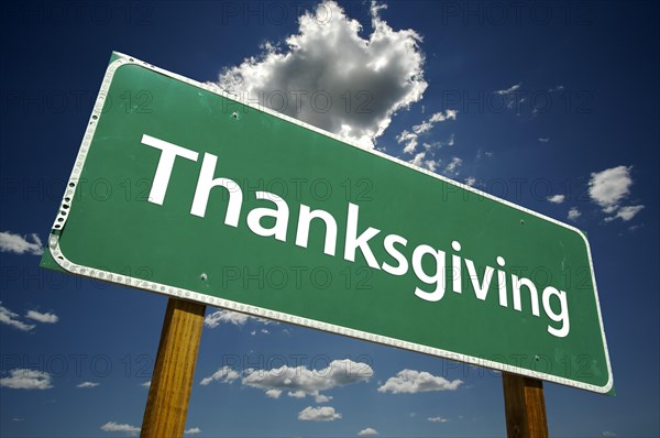 Thanksgiving road sign with dramatic clouds and sky