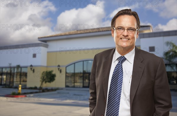 Handsome bussinesman in front of vacant office building