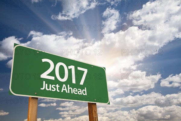 2017 just ahead green road sign against dramatic clouds and sky