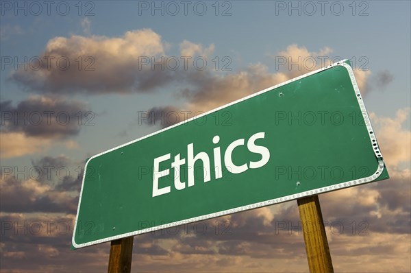 Ethics green road sign with dramatic blue sky and clouds