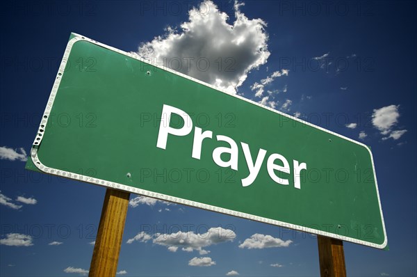 Prayer road sign with dramatic clouds and sky