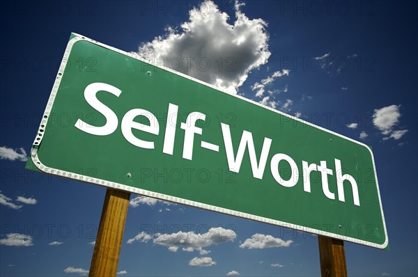 Self-Worth road sign with dramatic clouds and sky