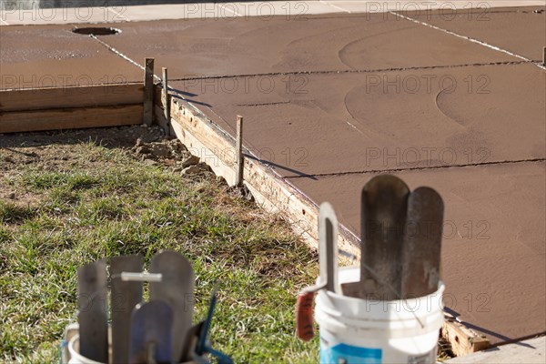 Freshly poured deck cement curing in wood frame