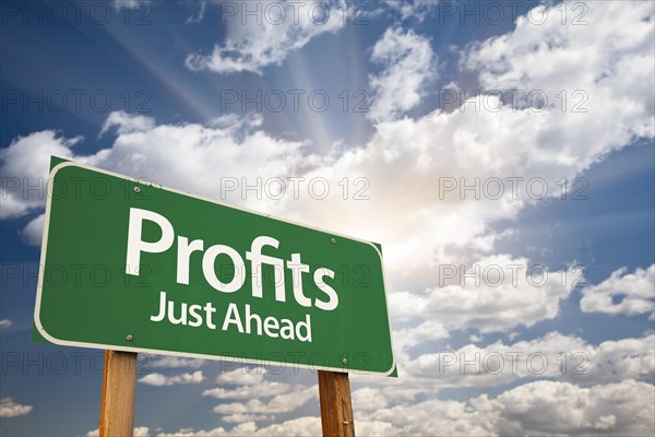 Profits green road sign with dramatic clouds and sky