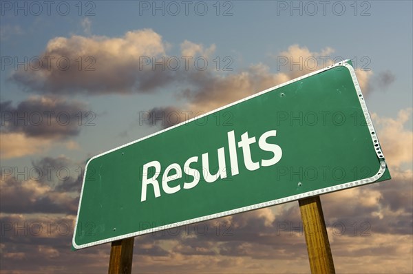 Results green road sign with dramatic blue sky and clouds