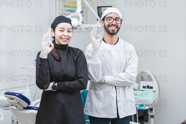 Portrait of dentist and her assistant in the office