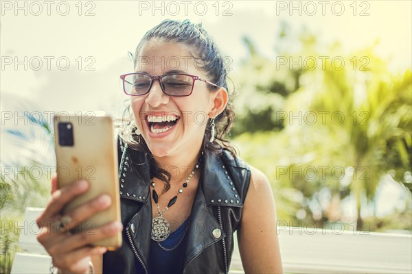 Close up of a happy girl checking her cell phone