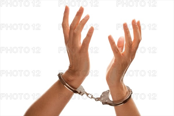 Handcuffed woman desperately raising hands in air isolated on a white background