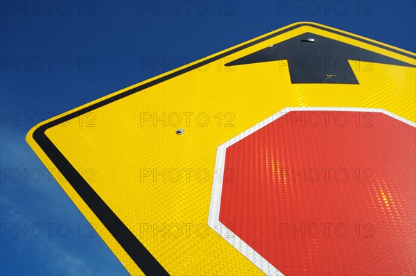 Very reflective stop ahead sign abstract on a blue sky