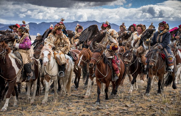 Parade of eagle hunters at the opening ceremony of the Eagle Festival. Mongolia