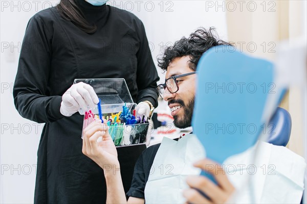 Patient with dentist choosing dental braces