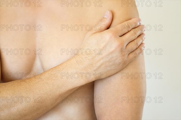 Adult male feeling shoulder pain