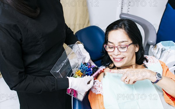 Patient with dentist choosing dental braces