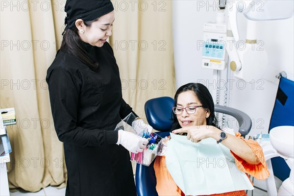 Patient with dentist choosing dental braces