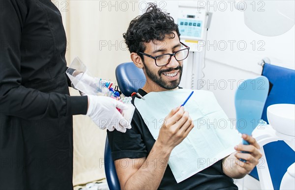 Patient with dentist choosing dental braces