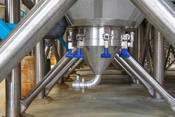 Large beer brewery fermentation tanks in warehouse