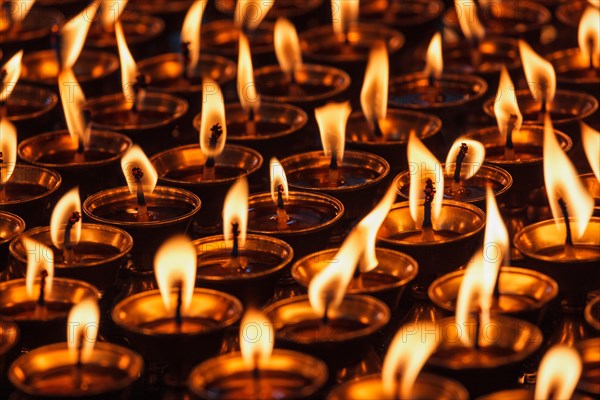 Burning candles in Buddhist temple Dharamsala