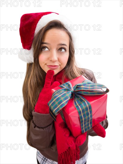 Thinking girl wearing A christmas santa hat with bow wrapped gift isolated on white