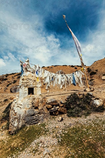 Tibetan Buddhist prayer flags lungta with Om mani padme hum mantra written on them in Spiti Valley in Himalayas