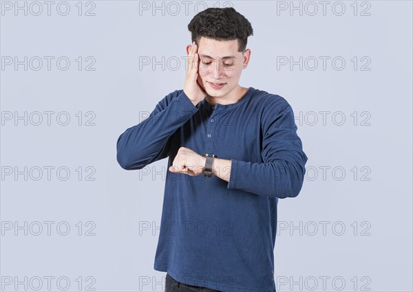 Young man looking at the watch time worried