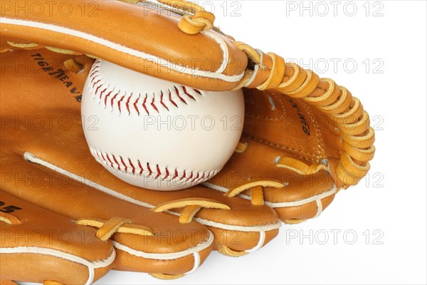 Baseball catcher mitt with ball isolated on white background close up