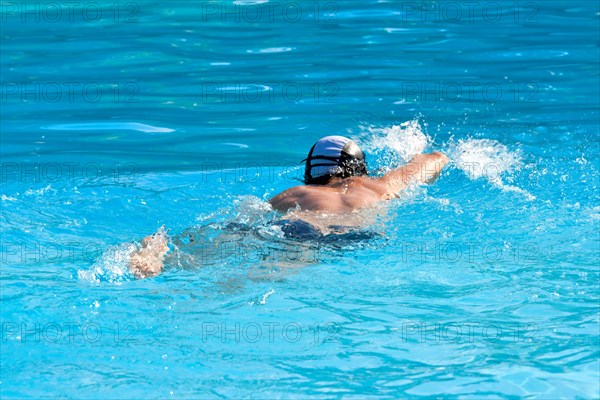 Athletic Man swimming in the pool