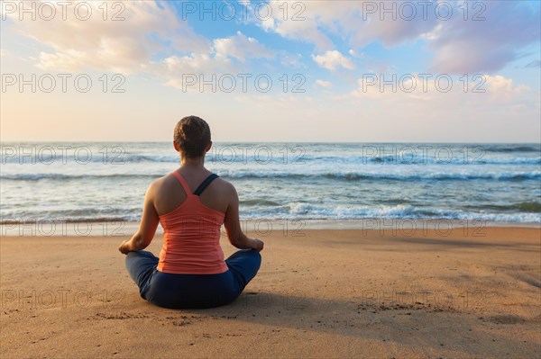 Young sporty fit woman doing yoga