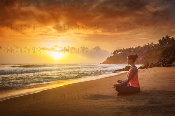 Young sporty fit woman doing yoga