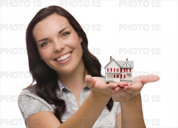 mixed-race woman holding small house isolated on white background