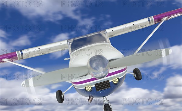 The front of A cessna 172 single propeller airplane in the sky