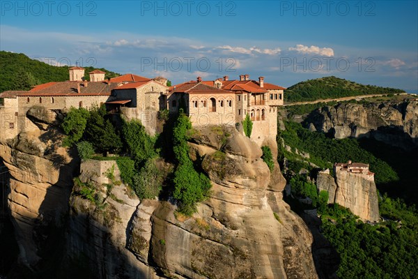 Monastery of Varlaam monastery and Monastery of Rousanou in famous greek tourist destination Meteora in Greece on sunset with scenic scenery landscape