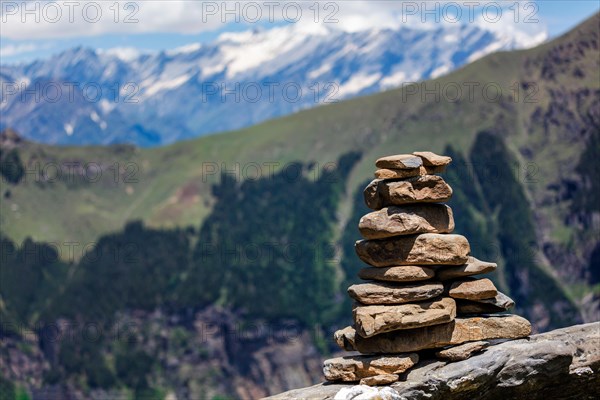 Stone cairn in Himalayas with mountains in background. Near Manali