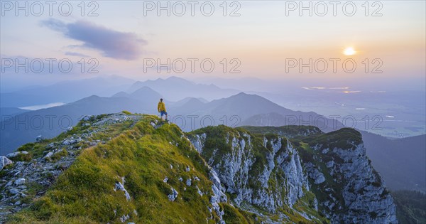 Hikers at the summit of the Benediktenwand at sunset