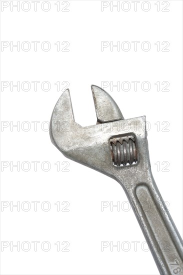 Old adjustable spanner isolated on white background