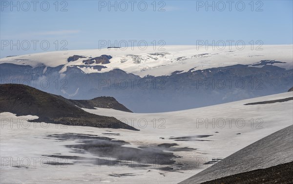 Barren hilly volcanic landscape of snow and lava fields